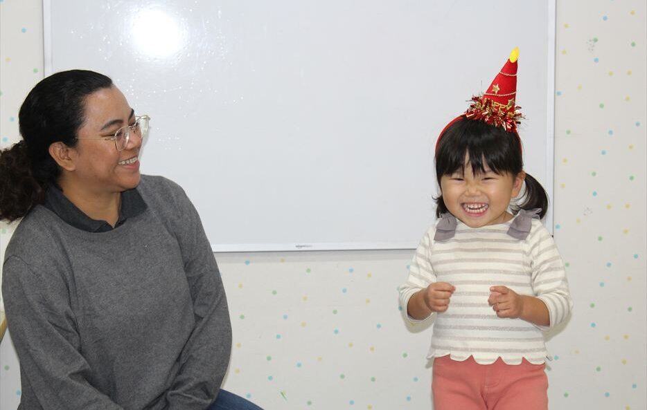 A child wearing a birthday hat in class.