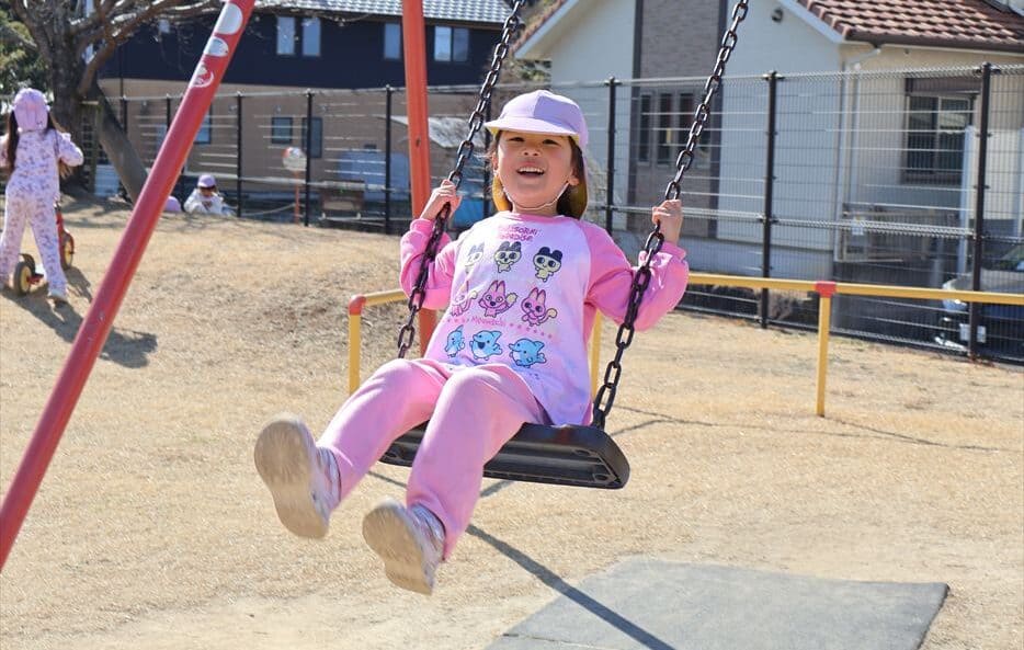 Girl swinging on swing at Hilltop