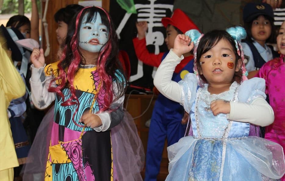 Two children singing at Hilltop's Halloween party.