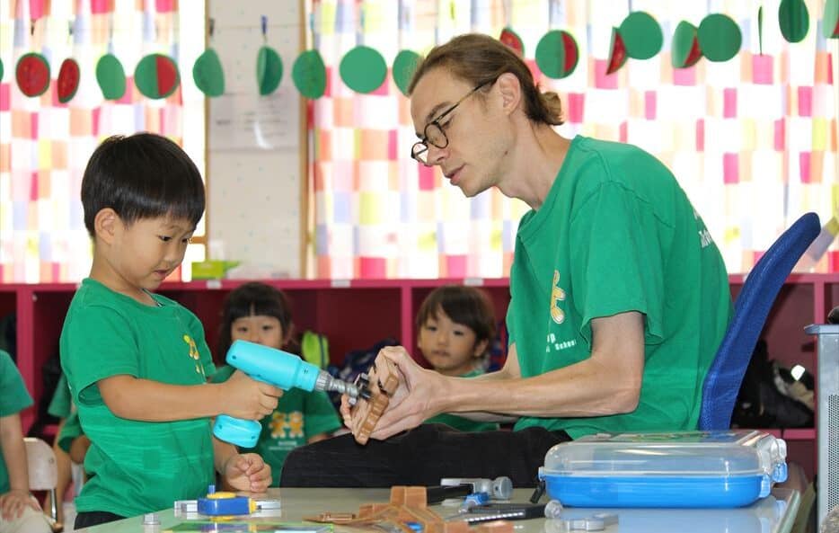 A child being taught by his teacher about tools and tool safety.