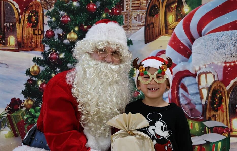 Young boy next to Santa at Hilltop International School.