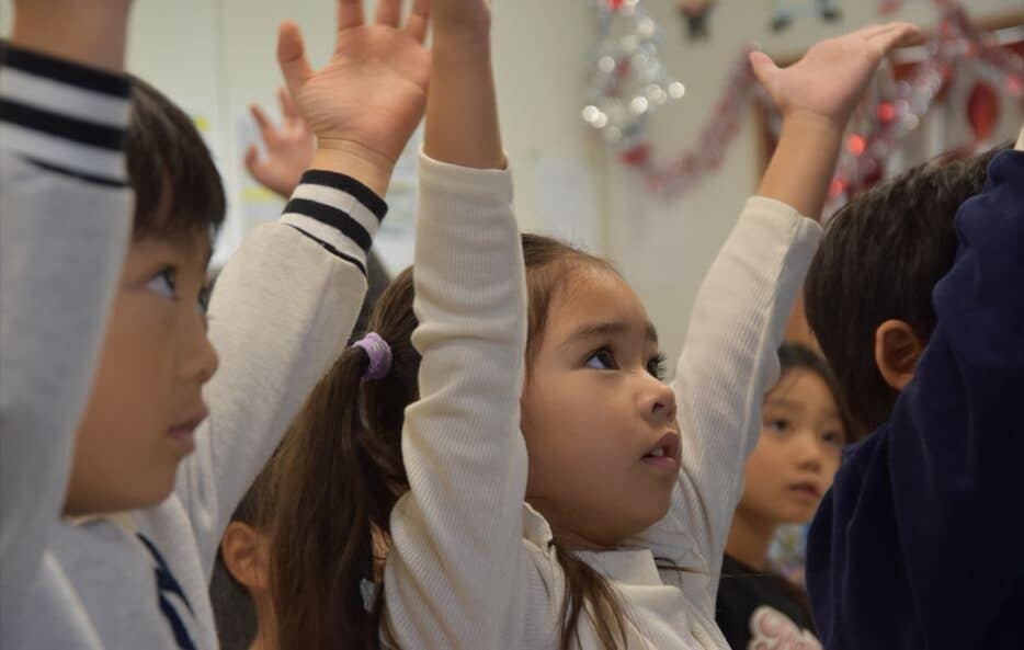 Children singing Christmas songs and dancing at Hilltop International School.