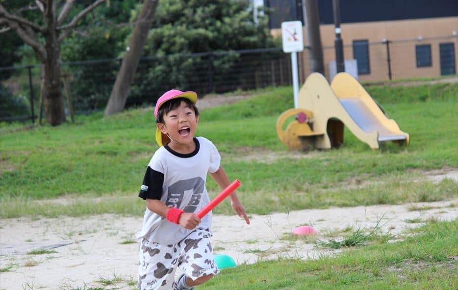 A young boy getting ready to pass the baton during the relay.