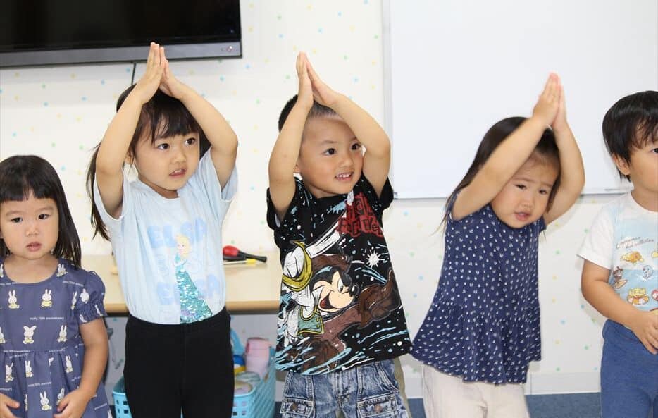 Young children in class dancing.