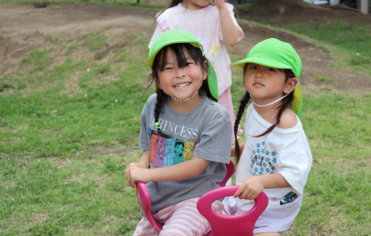 熊本のヒルトップインターナショナルスクールで、休み時間に元気に遊ぶ子供たち。A group of young children playing together during recess at Hilltop International School in Kumamoto.